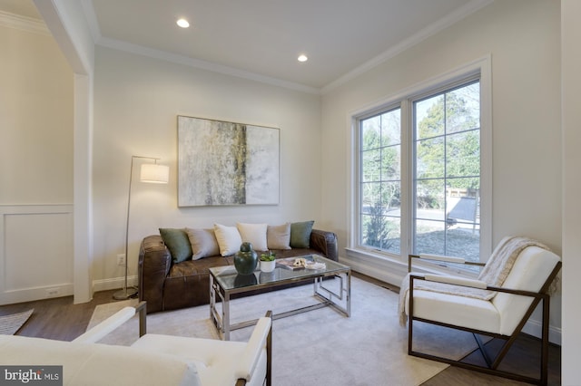 living area with ornamental molding, recessed lighting, and light wood-style floors