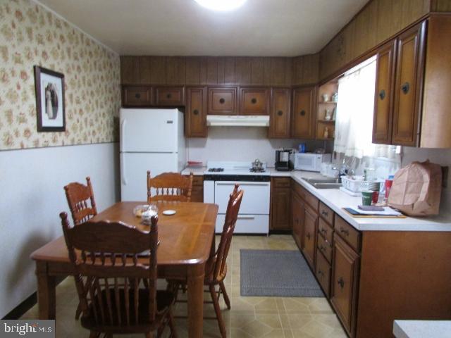 kitchen with white appliances and sink