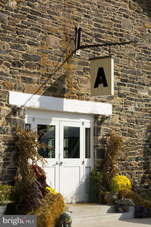 view of exterior entry featuring french doors