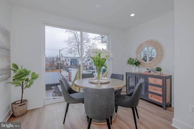 dining area with baseboards, light wood-style flooring, and recessed lighting