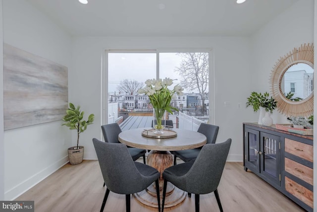 dining space with light wood-type flooring, baseboards, and recessed lighting