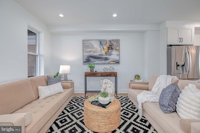 living room featuring baseboards, wood finished floors, and recessed lighting