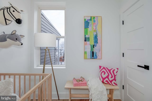 bedroom with a nursery area and baseboards