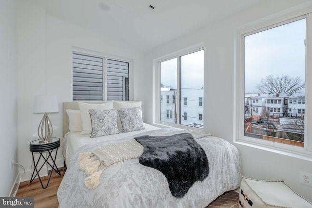 bedroom featuring baseboards and wood finished floors