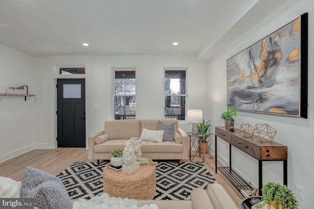 living room with baseboards, wood finished floors, and recessed lighting