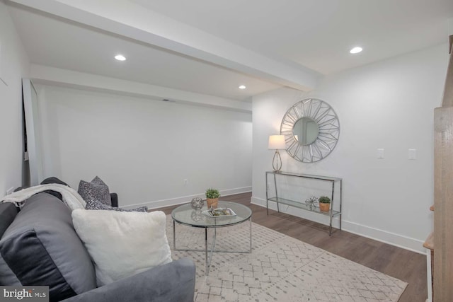 living room featuring recessed lighting, baseboards, beamed ceiling, and wood finished floors