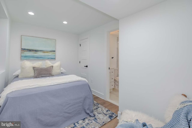 bedroom with baseboards, wood finished floors, and recessed lighting