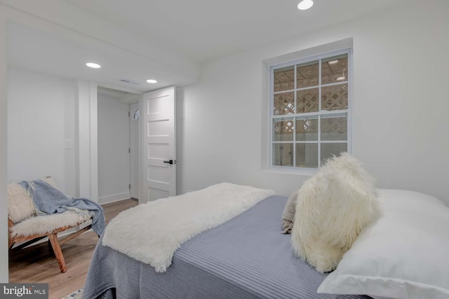 bedroom with wood finished floors and recessed lighting