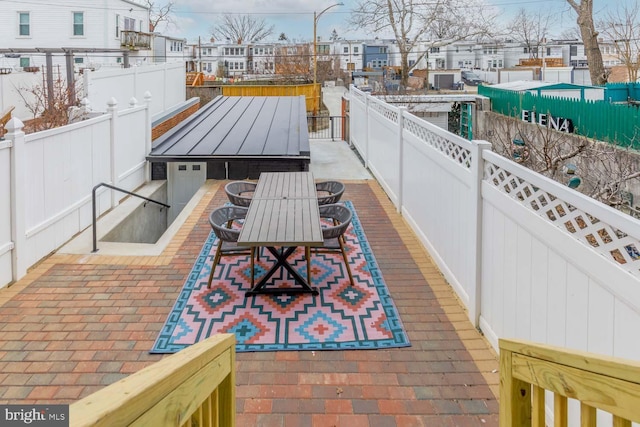 view of patio featuring fence private yard, outdoor dining area, and a residential view