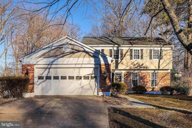 view of front of house with an attached garage, driveway, and brick siding