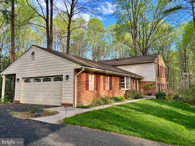 view of front of property with a garage and a front lawn