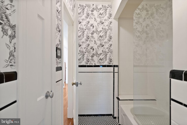 full bath with a shower, a tub to relax in, wallpapered walls, and tile walls