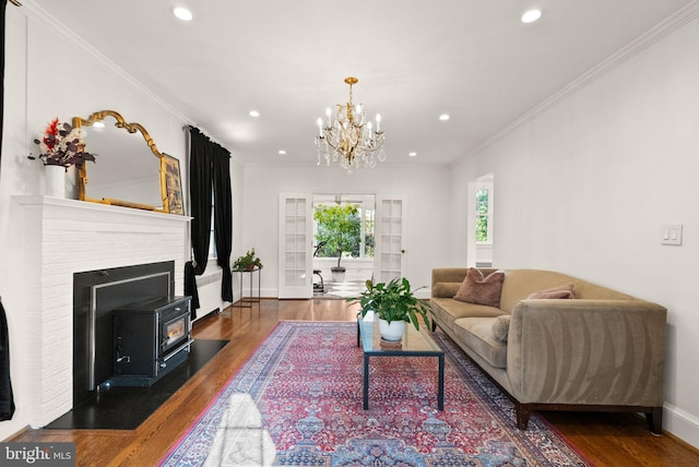 living area featuring wood finished floors, a chandelier, crown molding, recessed lighting, and baseboards