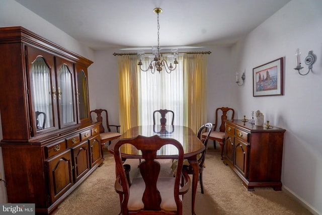 dining room featuring an inviting chandelier and light carpet