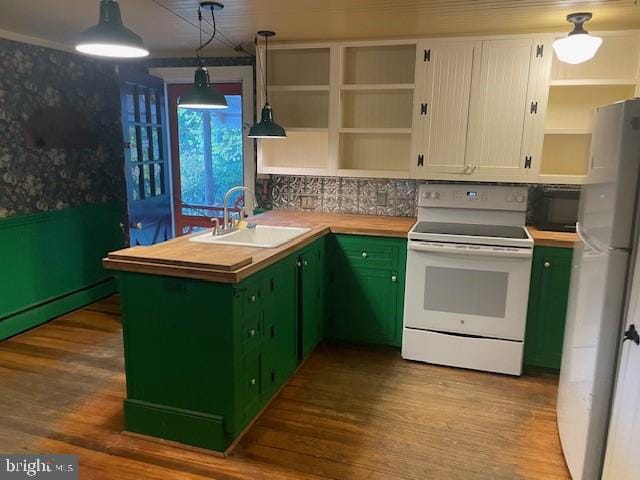 kitchen with white range with electric stovetop, hanging light fixtures, sink, fridge, and white cabinets