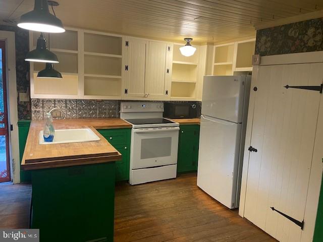 kitchen featuring green cabinetry, butcher block countertops, decorative light fixtures, white appliances, and white cabinets