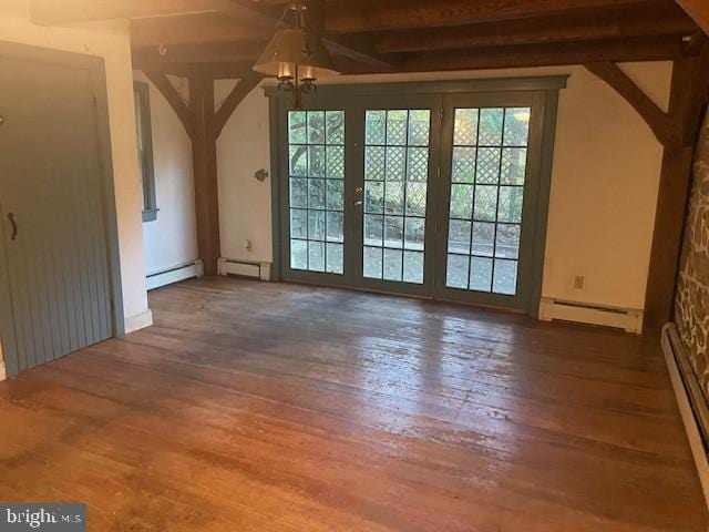 interior space featuring a baseboard heating unit, dark hardwood / wood-style floors, and plenty of natural light