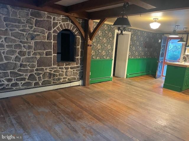 interior space with hardwood / wood-style flooring, beam ceiling, and a baseboard radiator