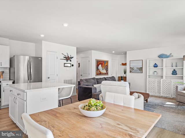 dining room featuring recessed lighting and light wood-style flooring