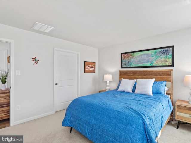 carpeted bedroom with visible vents and baseboards