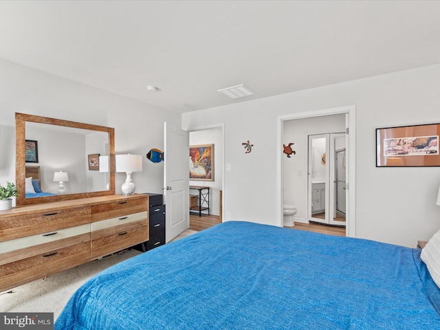 bedroom with visible vents and connected bathroom