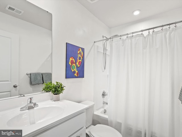 full bathroom featuring visible vents, toilet, vanity, and shower / tub combo with curtain