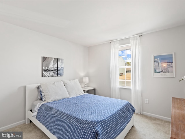 bedroom with baseboards and carpet floors