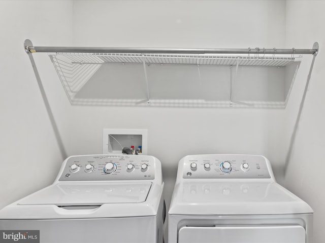 washroom featuring laundry area and separate washer and dryer