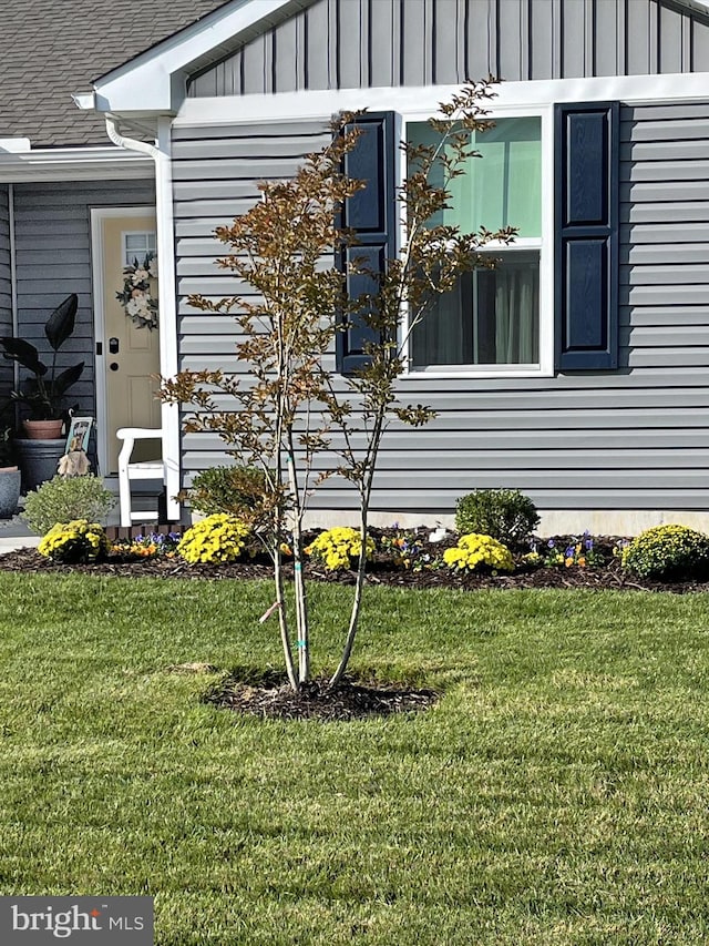 view of home's exterior with a lawn and board and batten siding