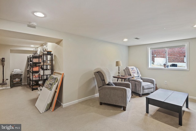 living area featuring visible vents, baseboards, and light colored carpet