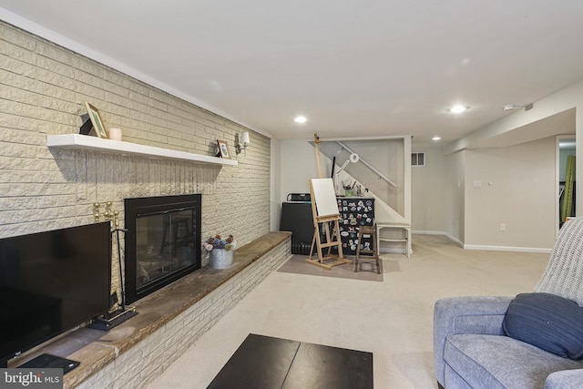 living room with baseboards, visible vents, carpet floors, a brick fireplace, and recessed lighting