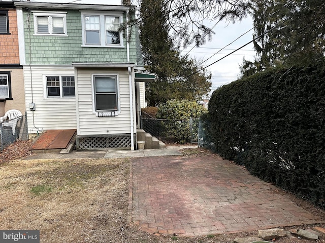 back of house featuring fence