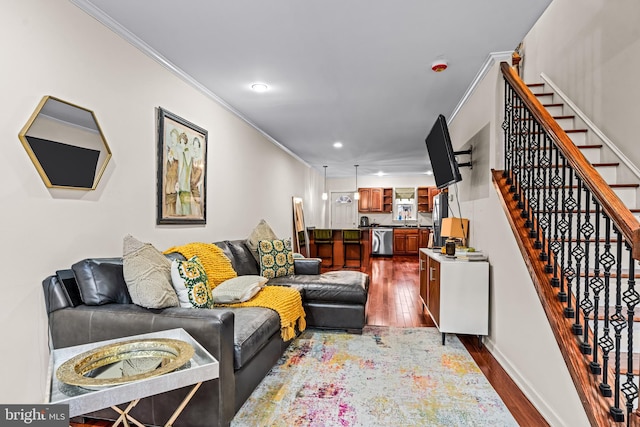 living room with hardwood / wood-style floors and crown molding