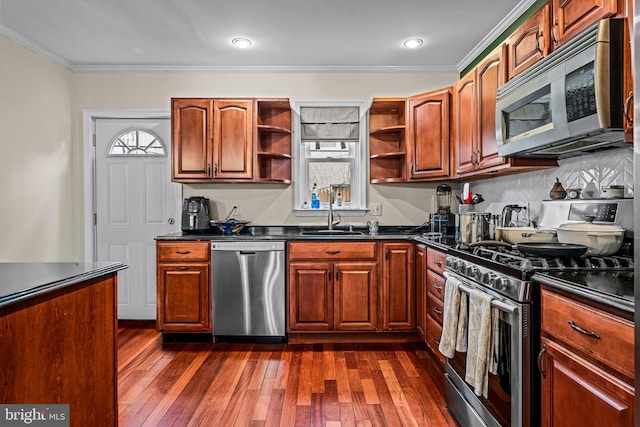 kitchen with sink, backsplash, dark hardwood / wood-style flooring, ornamental molding, and stainless steel appliances