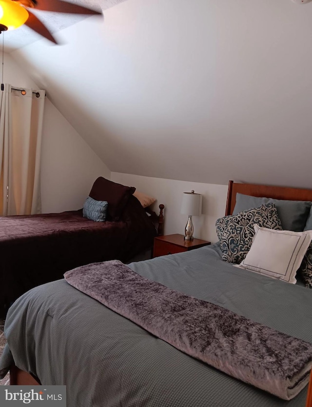 bedroom featuring vaulted ceiling and ceiling fan