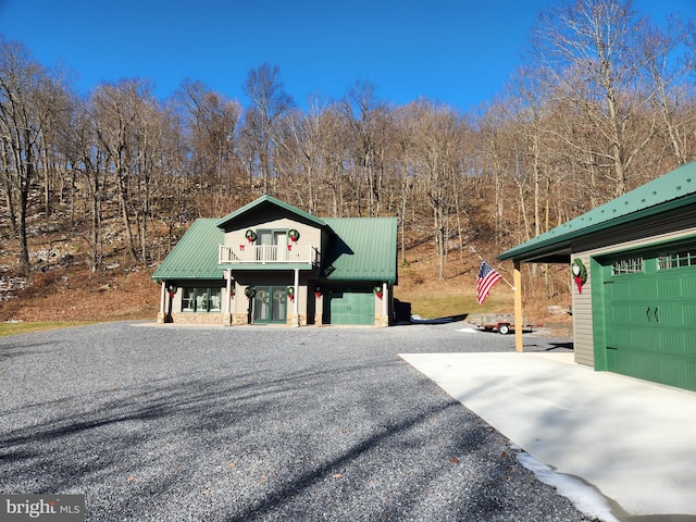 exterior space with a garage, metal roof, and driveway