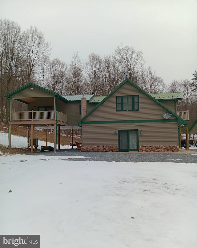 view of snow covered exterior featuring metal roof