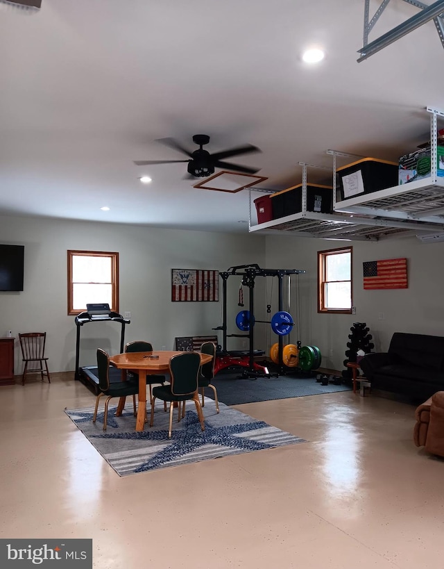 interior space with recessed lighting, a healthy amount of sunlight, ceiling fan, and finished concrete flooring