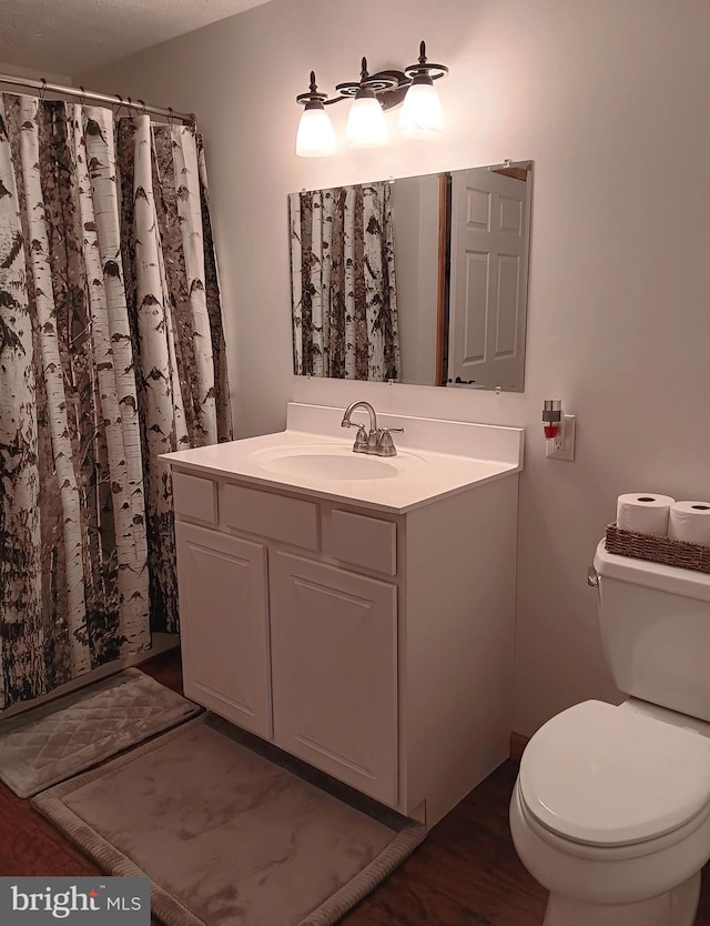 full bath featuring toilet and vanity