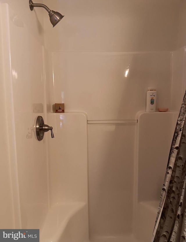 bathroom with a shower with shower curtain