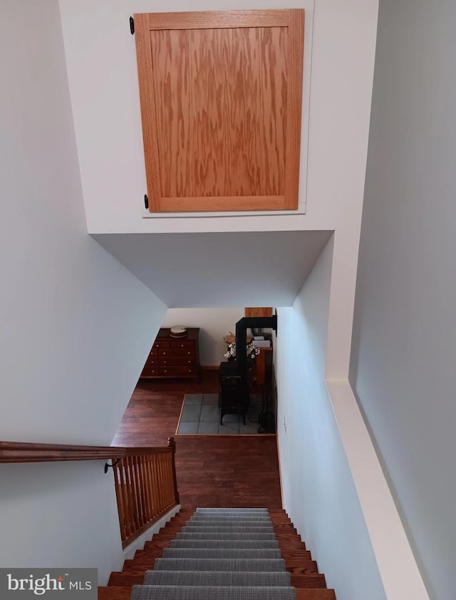 staircase with wood finished floors