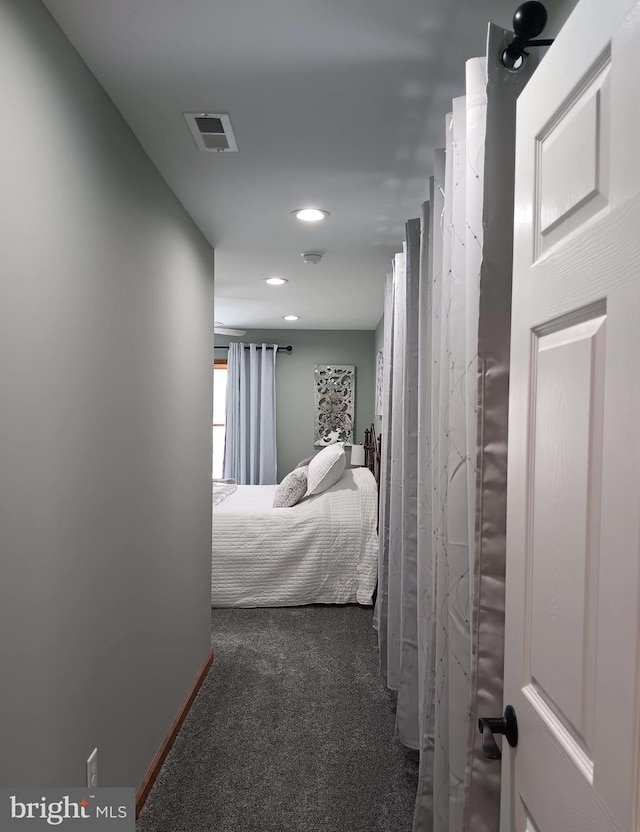 bedroom with baseboards, visible vents, dark colored carpet, and recessed lighting