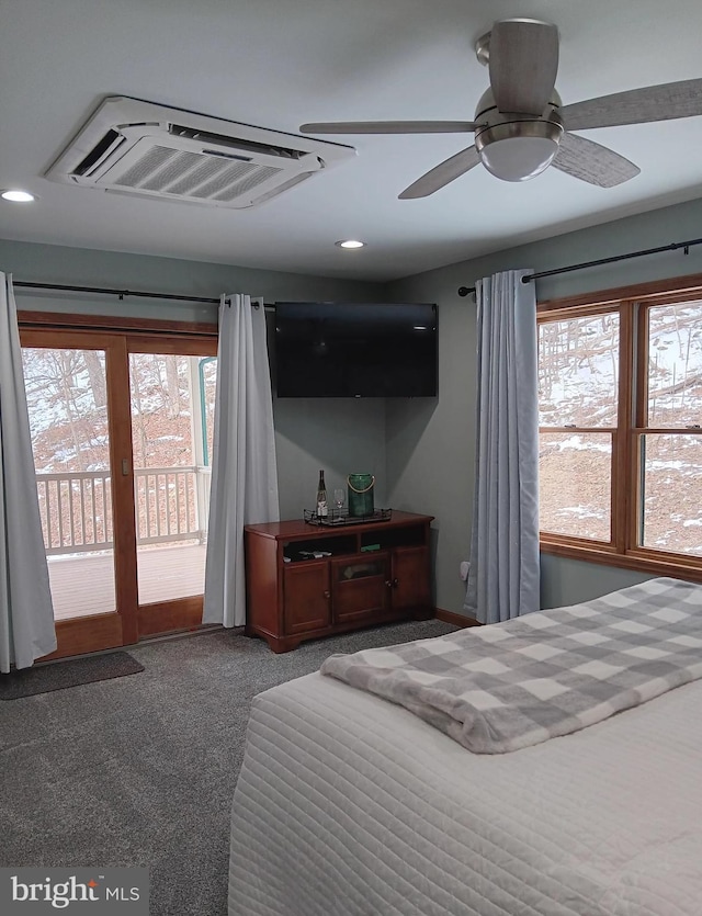 carpeted bedroom with access to exterior, multiple windows, visible vents, and a ceiling fan