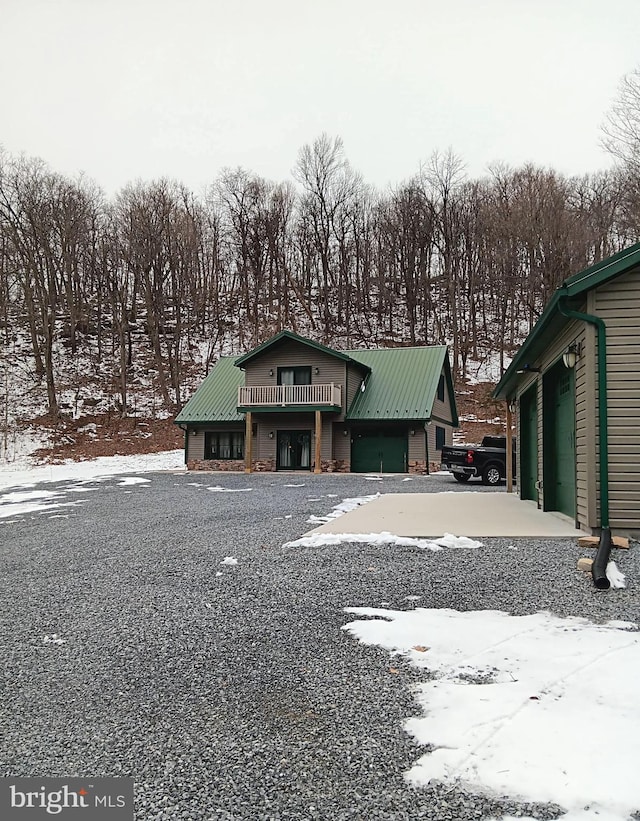 view of front of house featuring a garage and metal roof