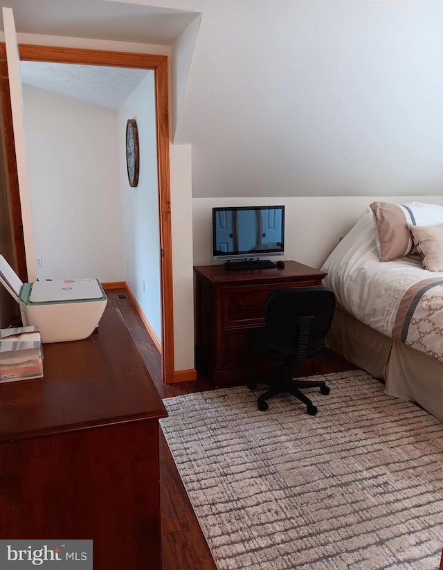 bedroom featuring baseboards and light wood finished floors