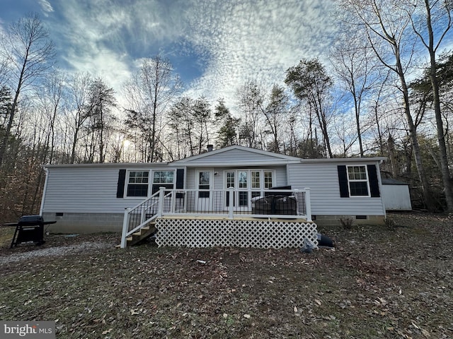 manufactured / mobile home featuring crawl space and a deck