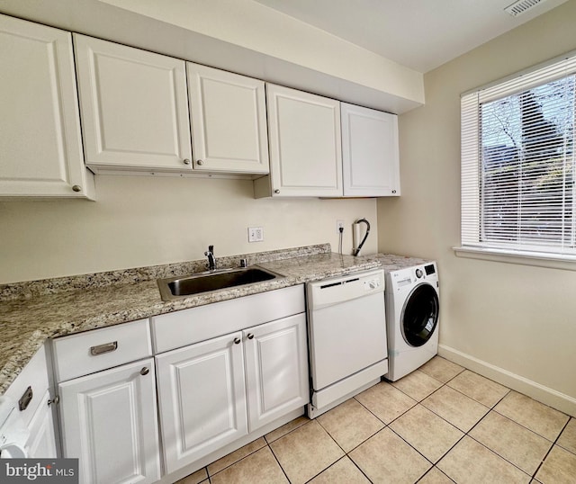 laundry area with a sink, washer / clothes dryer, light tile patterned flooring, baseboards, and laundry area