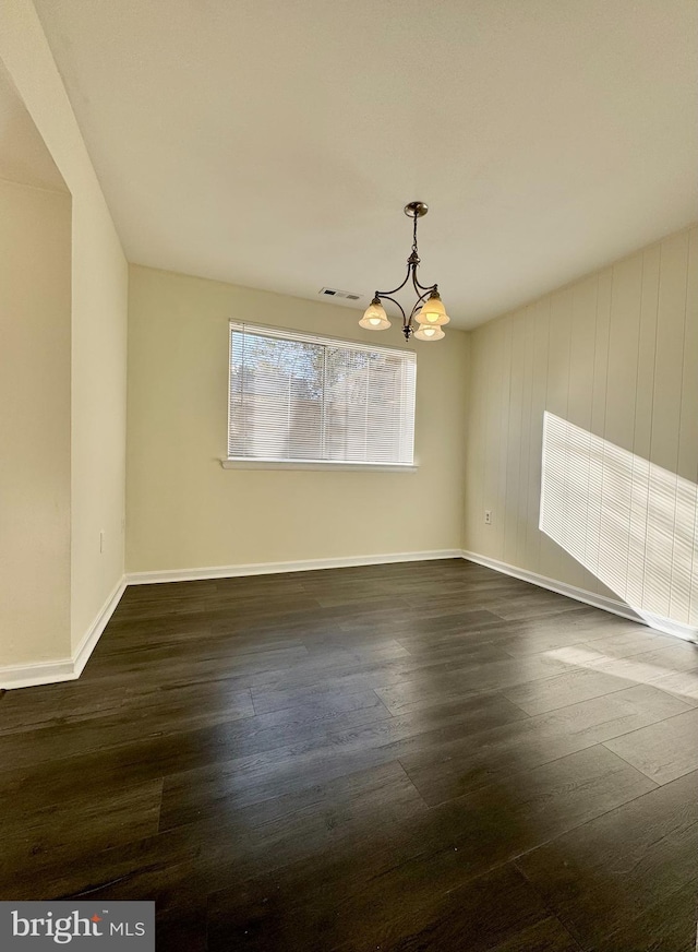 interior space featuring dark wood-type flooring, baseboards, visible vents, and a chandelier