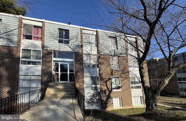 view of property with brick siding