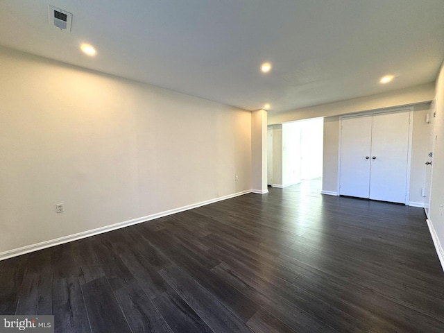 unfurnished bedroom with visible vents, recessed lighting, dark wood-type flooring, and baseboards